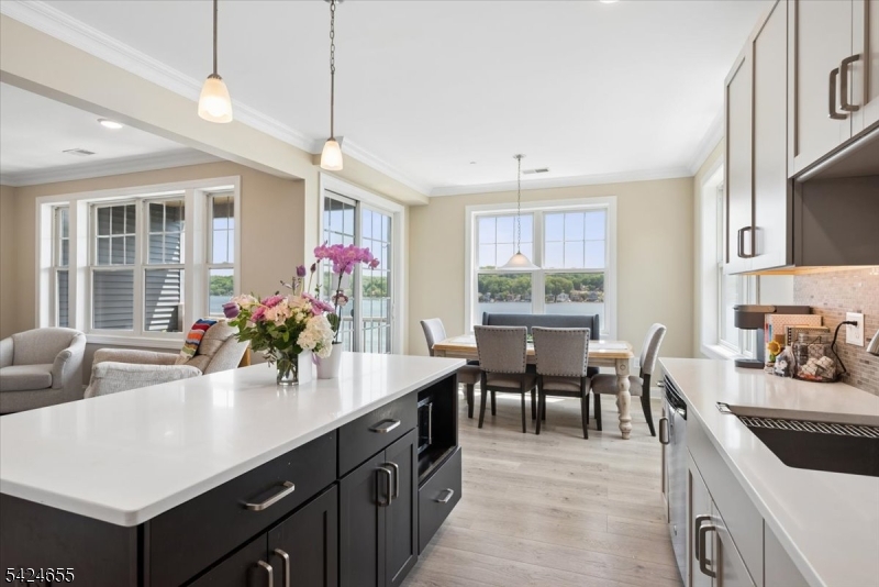 401 Mariners Pointe Hopatcong, NJ 07843 - Photo 16 of 42 a kitchen with sink cabinets and dining table