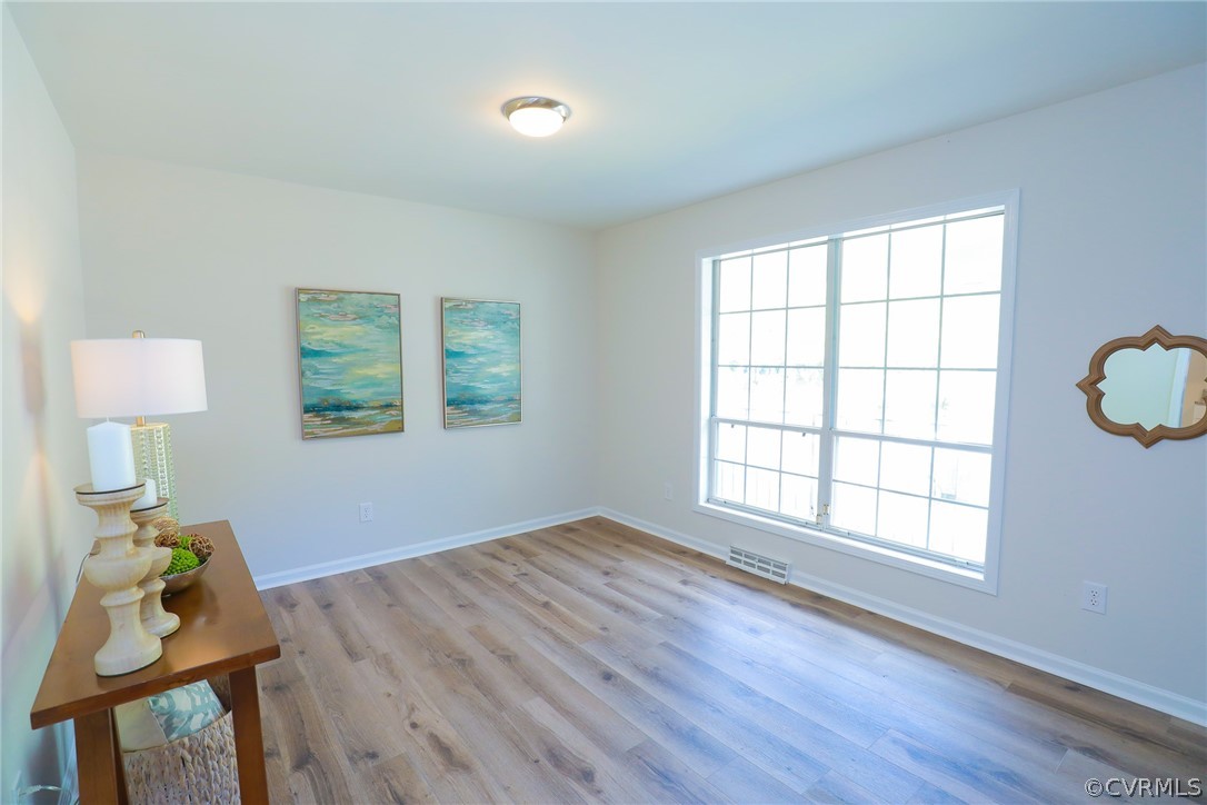6029 Barrister Road Chesterfield, VA 23832 - Photo 7 of 50 a view of an empty room with a window and wooden floor