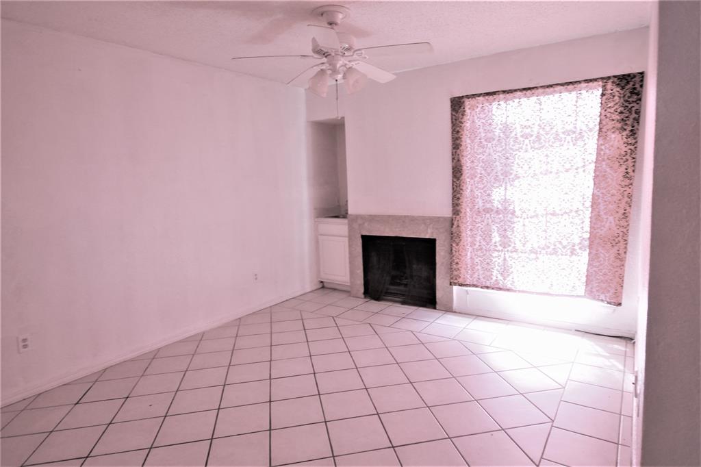 8003 Rothington Road, Unit 53 Dallas, TX 75227 - Photo 4 of 11 a view of empty room with fireplace