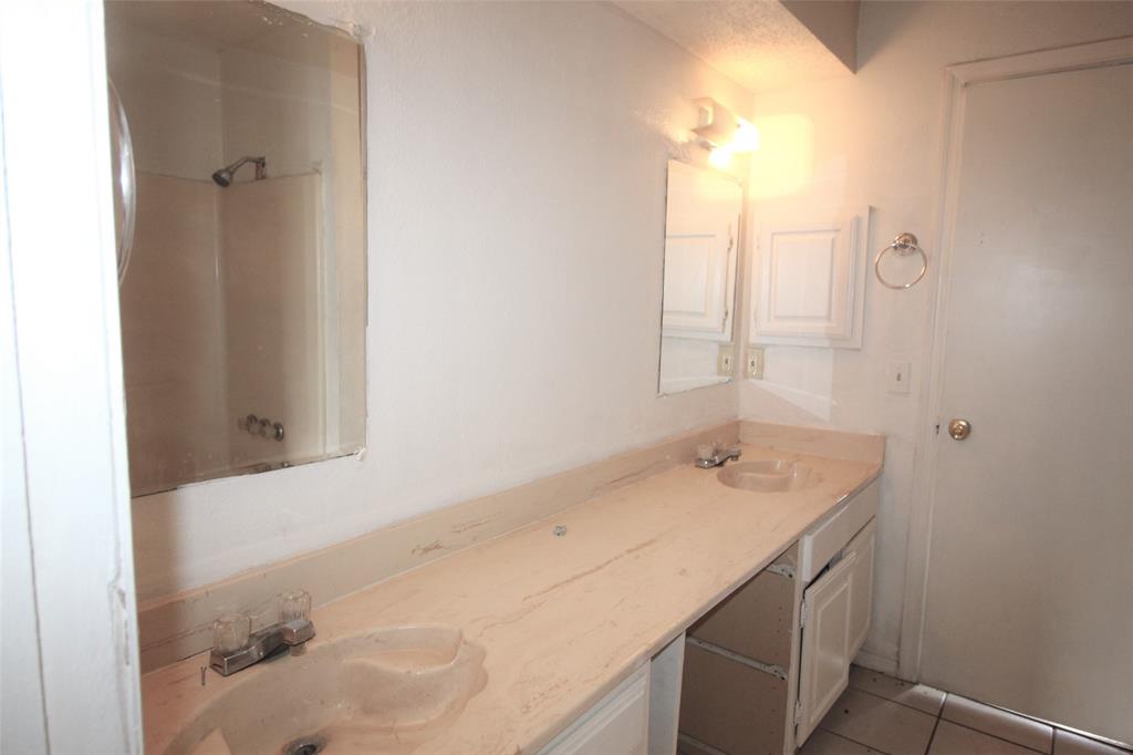 8003 Rothington Road, Unit 53 Dallas, TX 75227 - Photo 8 of 11 a bathroom with a granite countertop sink and a mirror