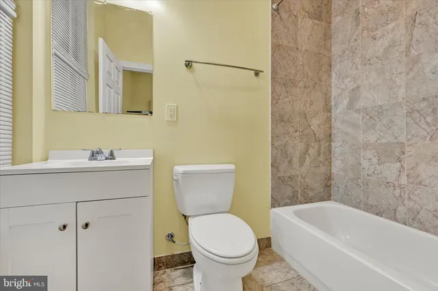 a bathroom with a sink a toilet and a bathtub