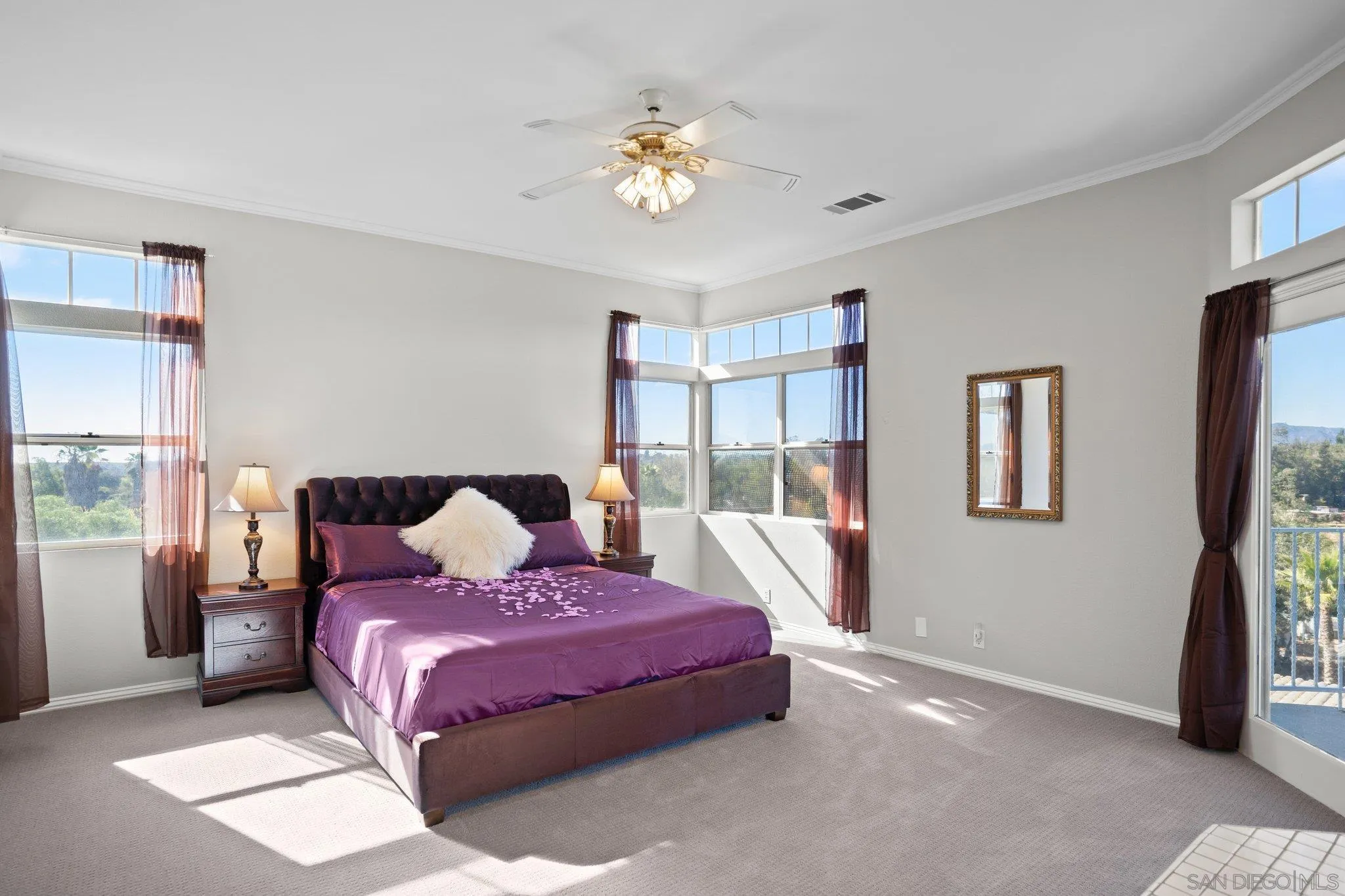 1267 Palomino Road Fallbrook, CA 92028 - Photo 20 of 34 a bedroom with a large bed and a chandelier