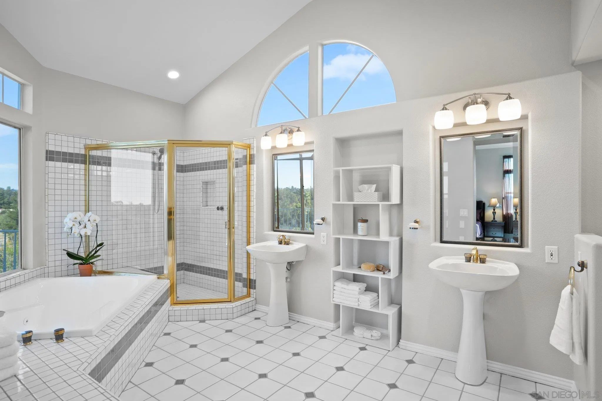 1267 Palomino Road Fallbrook, CA 92028 - Photo 23 of 34 a spacious bathroom with a double vanity sink a mirror a bathtub and a shower