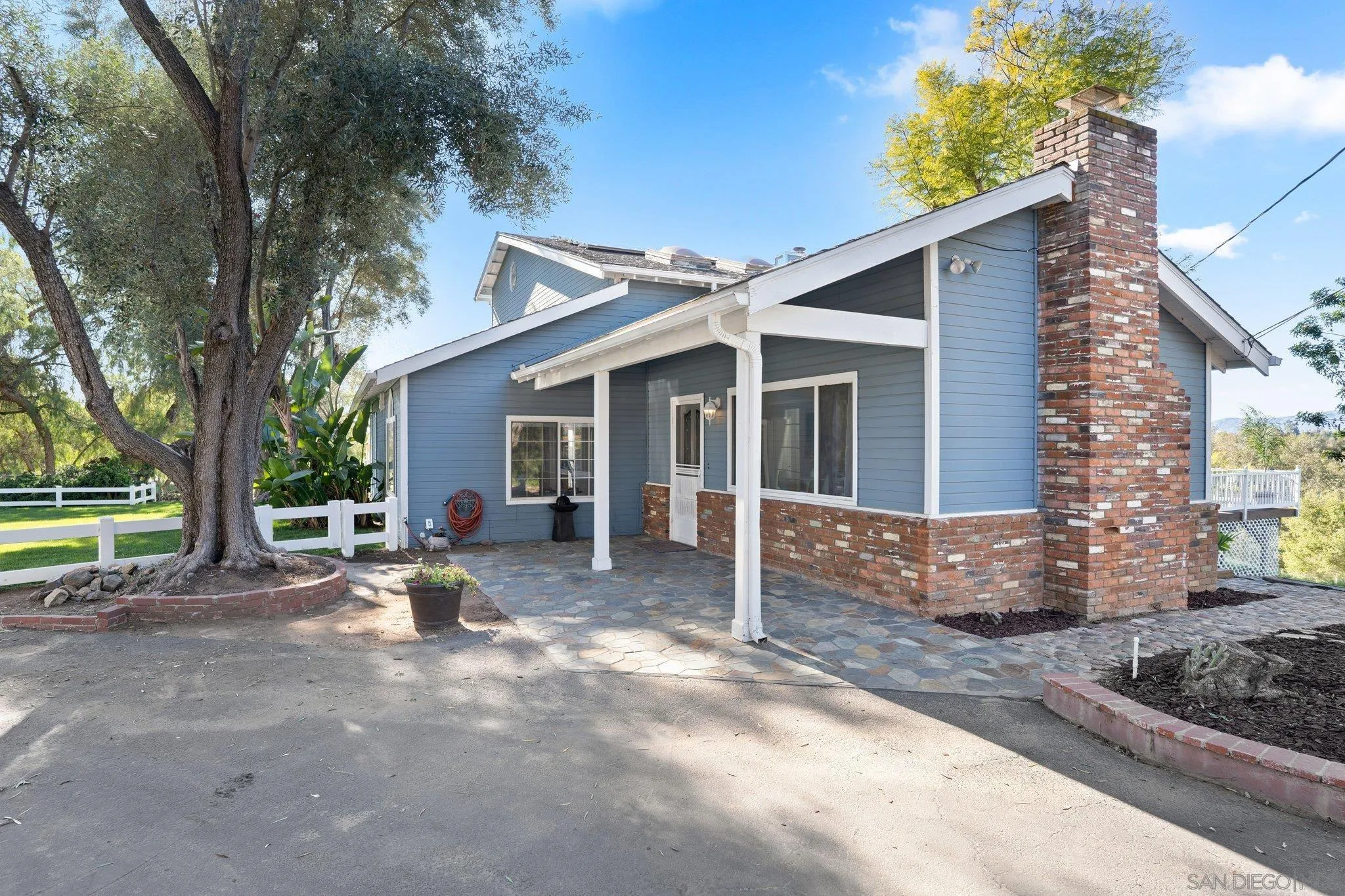 1267 Palomino Road Fallbrook, CA 92028 - Photo 6 of 34 a view of a house with backyard and a tree