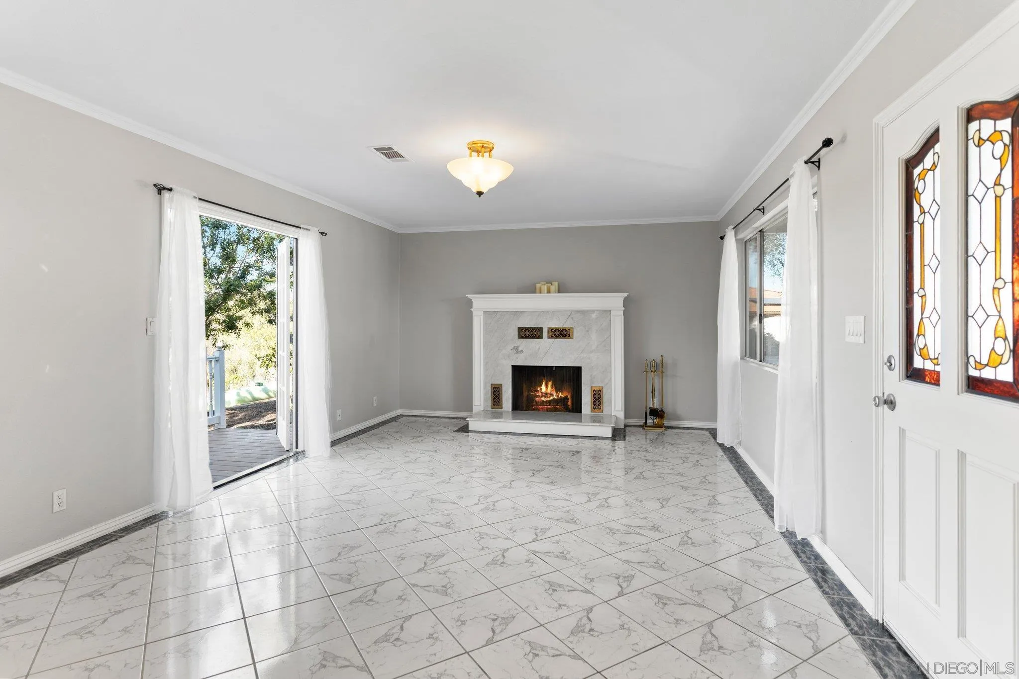 1267 Palomino Road Fallbrook, CA 92028 - Photo 8 of 34 an empty room with windows and fireplace