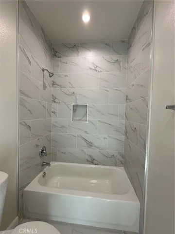 a bathroom with a bathtub and a toilet