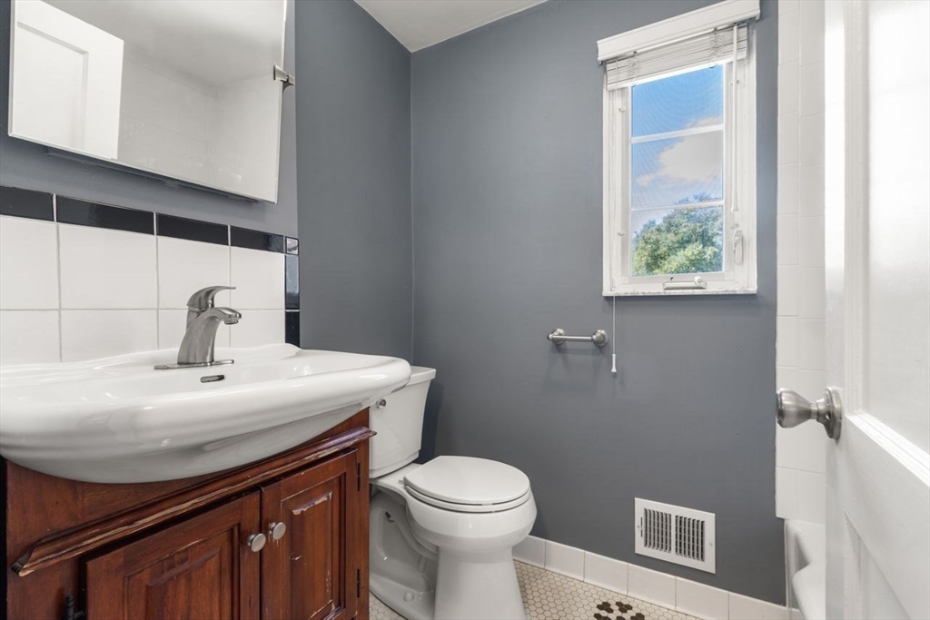 57 Pierce Road, Unit 57 Watertown, MA 02472 - Photo 12 of 22 a bathroom with a sink a toilet and shower