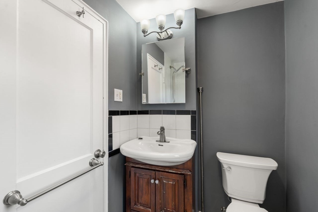 57 Pierce Road, Unit 57 Watertown, MA 02472 - Photo 14 of 22 a bathroom with a sink a toilet and shower