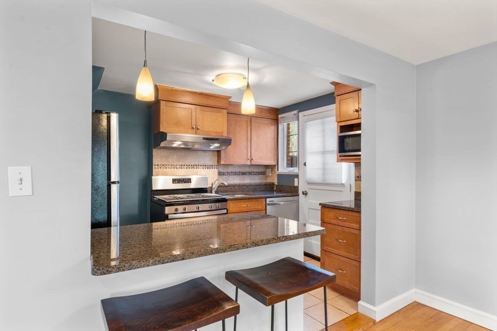 57 Pierce Road, Unit 57 Watertown, MA 02472 - Photo 2 of 22 a kitchen with stainless steel appliances granite countertop a stove and a refrigerator