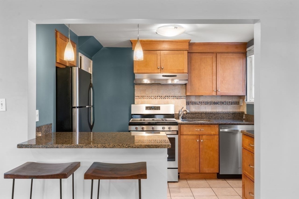 57 Pierce Road, Unit 57 Watertown, MA 02472 - Photo 5 of 22 a kitchen with stainless steel appliances granite countertop a stove a sink and a refrigerator
