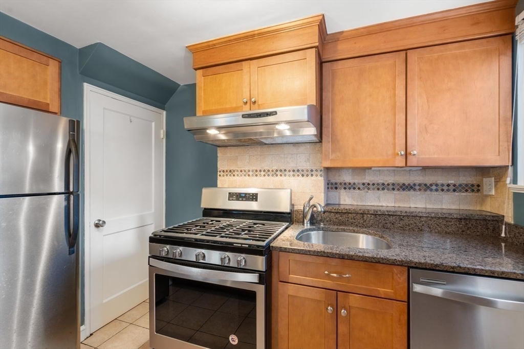 57 Pierce Road, Unit 57 Watertown, MA 02472 - Photo 6 of 22 a kitchen with stainless steel appliances granite countertop a refrigerator and a stove