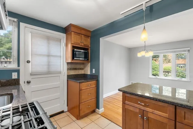 a kitchen with granite countertop a stove and a sink