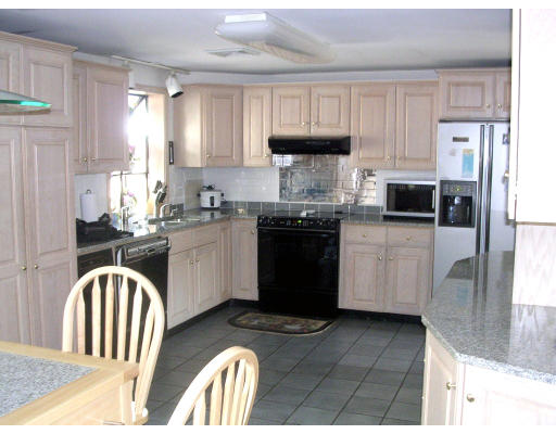 39 Locust Street Burlington, MA 01803 - Photo 2 of 5 a kitchen with stainless steel appliances granite countertop a stove a sink dishwasher and a refrigerator