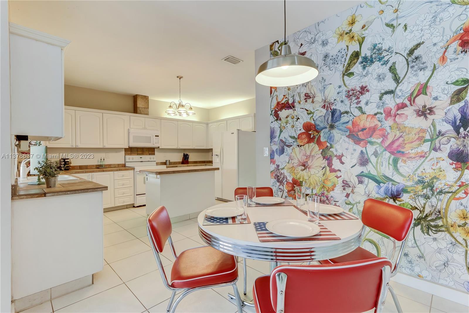 Bonaventure Lakes Weston, FL 33326 - Photo 11 of 52 a kitchen with stainless steel appliances kitchen island granite countertop a sink and a stove