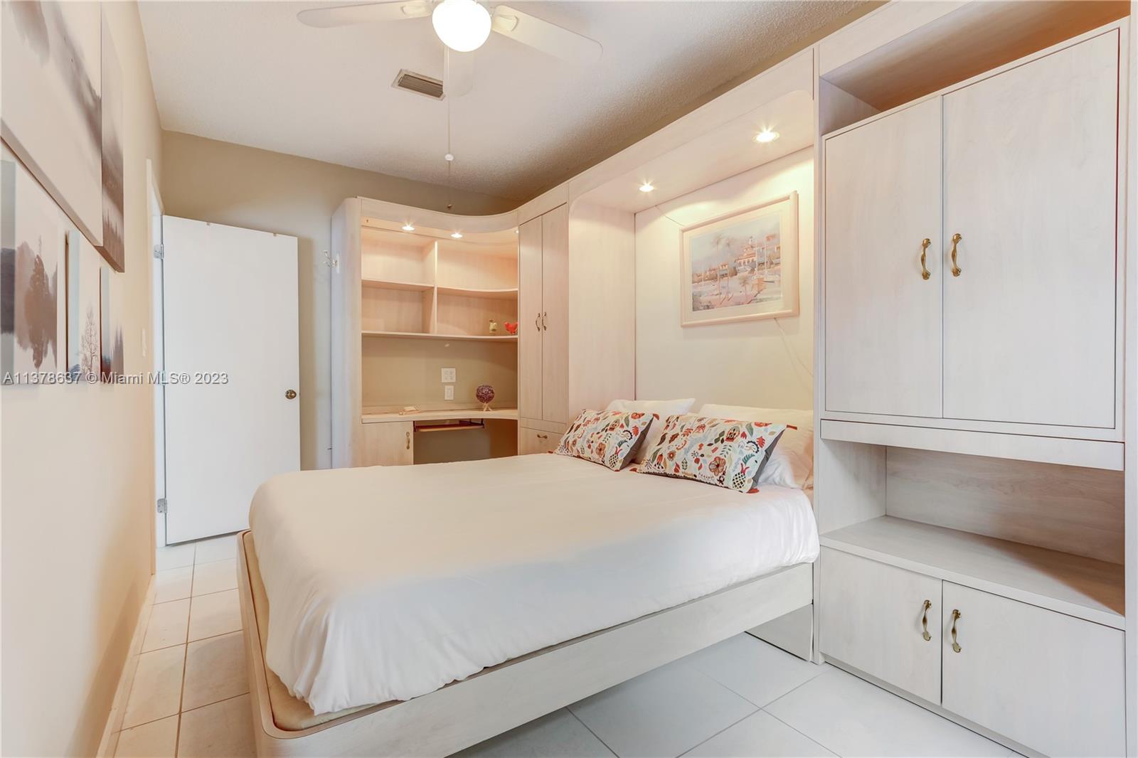 Bonaventure Lakes Weston, FL 33326 - Photo 16 of 52 a bedroom with a large bed and a chandelier