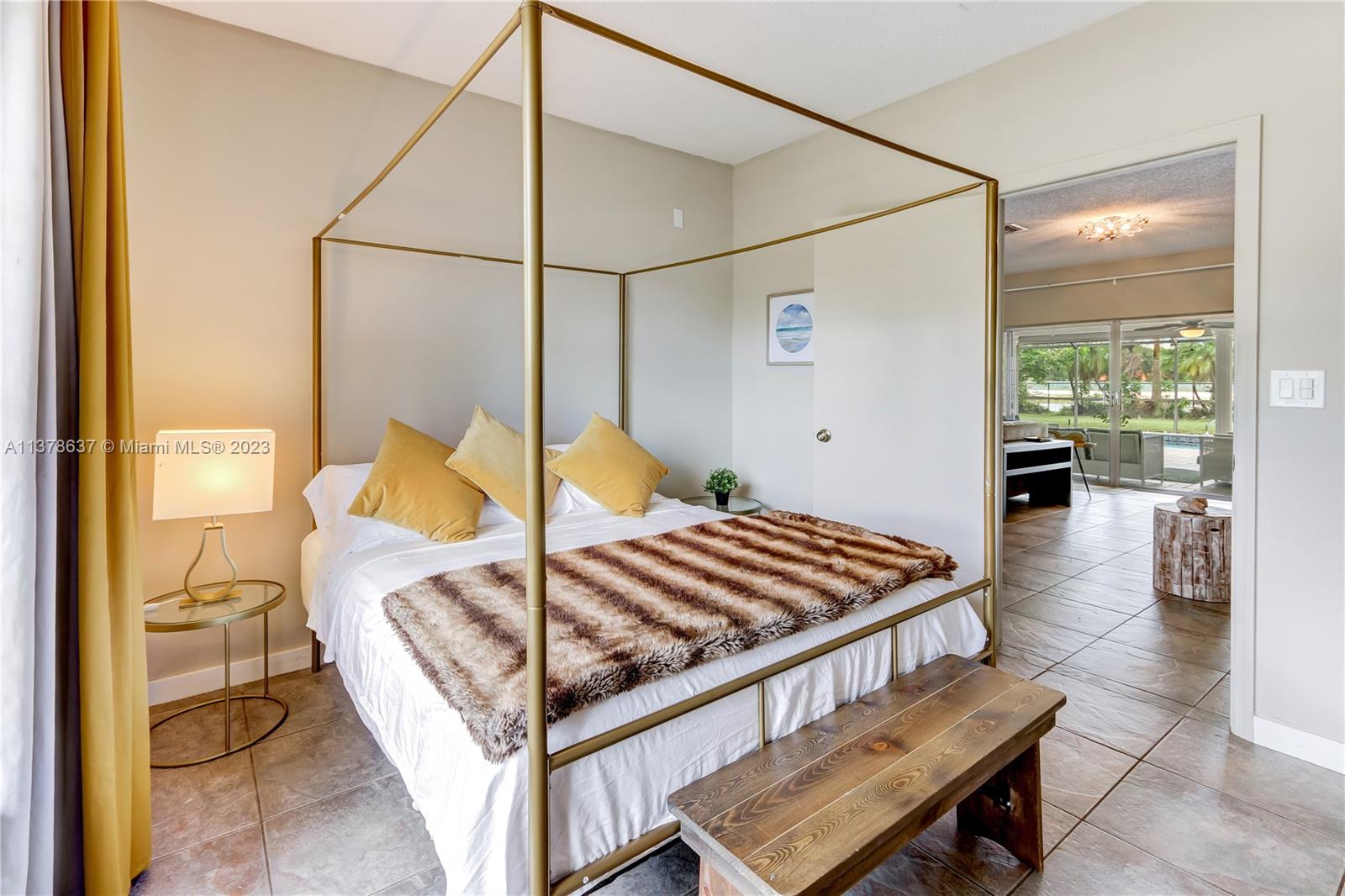 Bonaventure Lakes Weston, FL 33326 - Photo 21 of 52 a bedroom with a bed and wooden floor