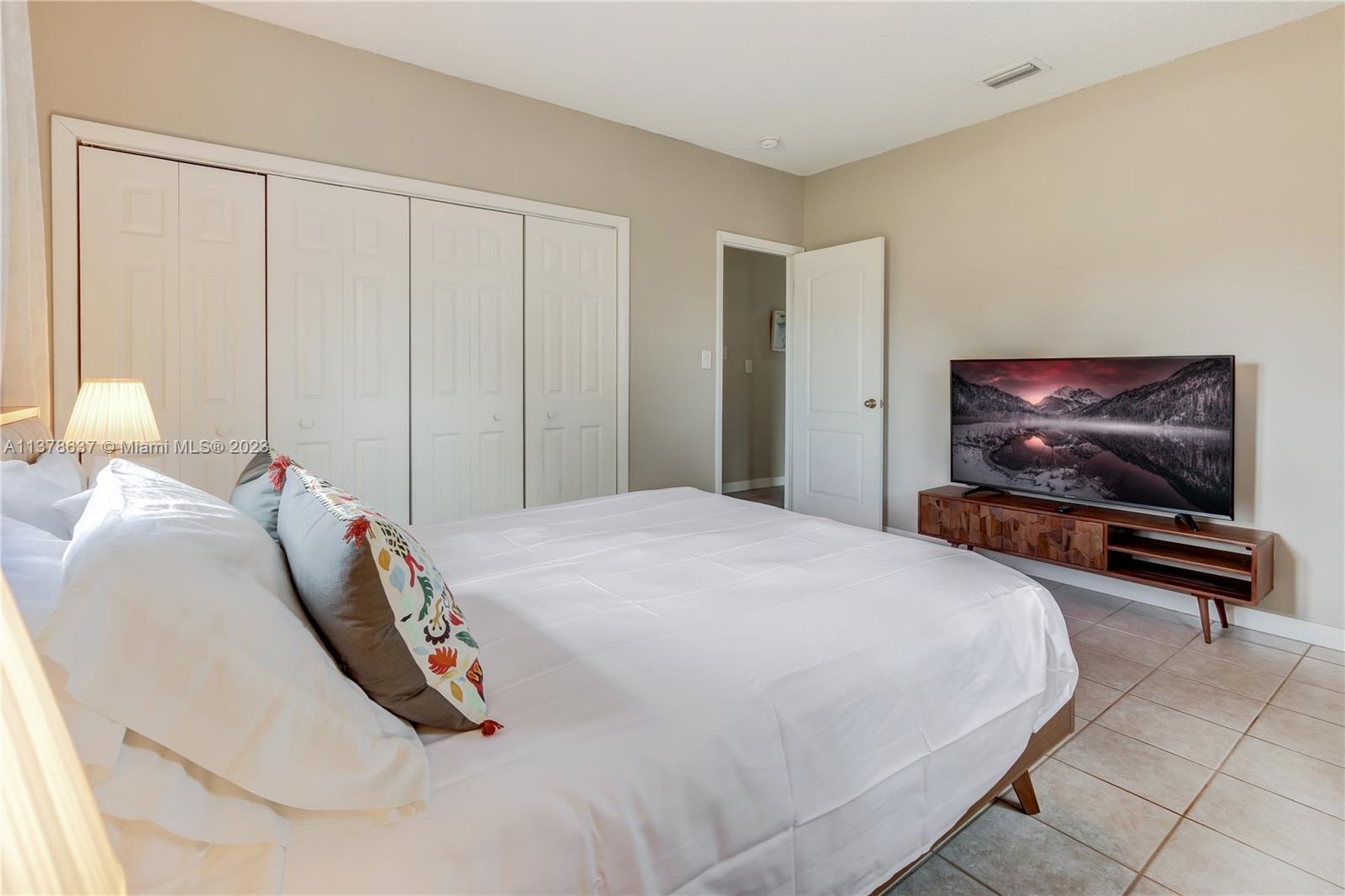 Bonaventure Lakes Weston, FL 33326 - Photo 30 of 52 a bedroom with a bed and a painting on the wall