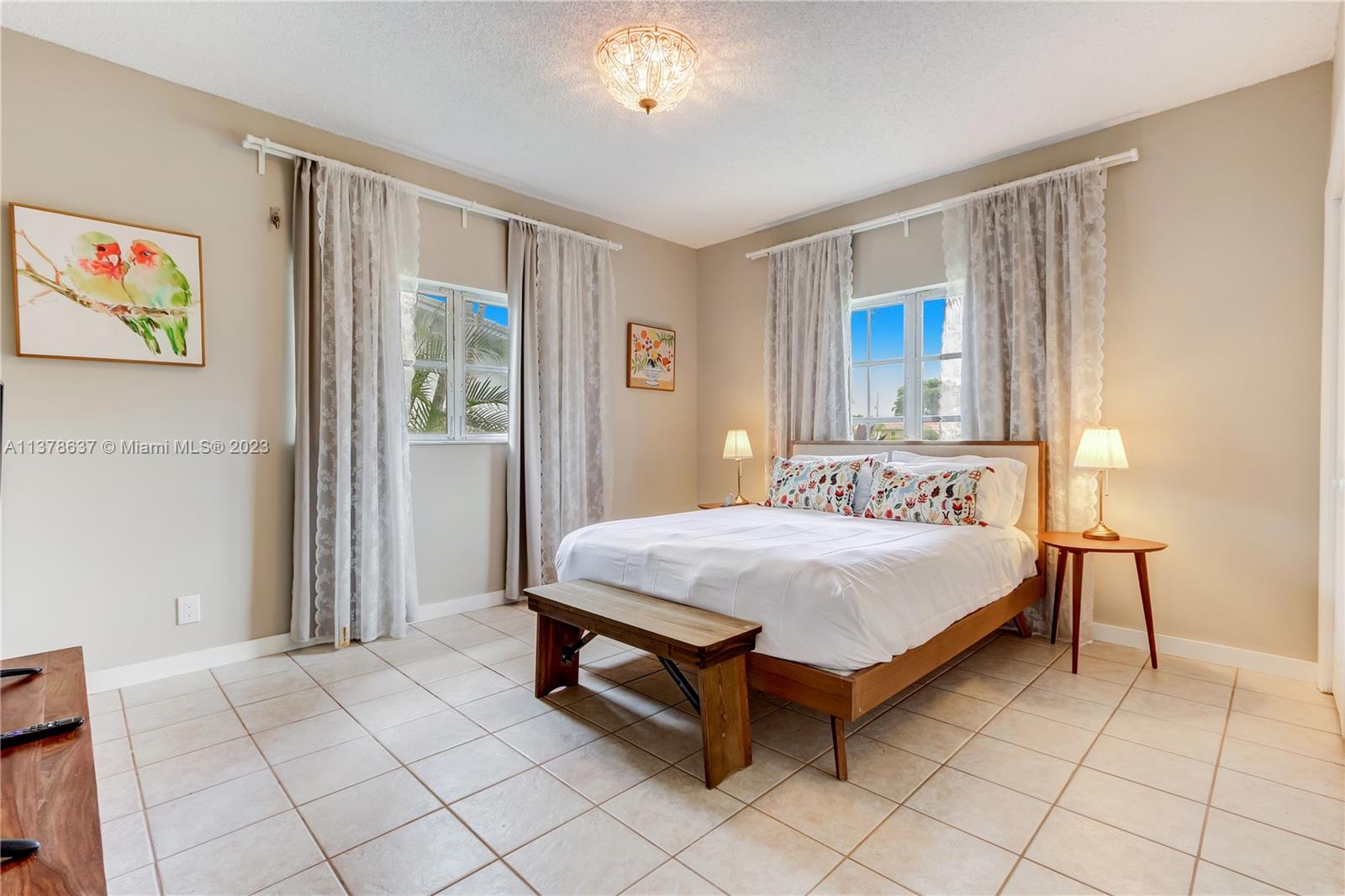 Bonaventure Lakes Weston, FL 33326 - Photo 31 of 52 a bedroom with a bed table and a window