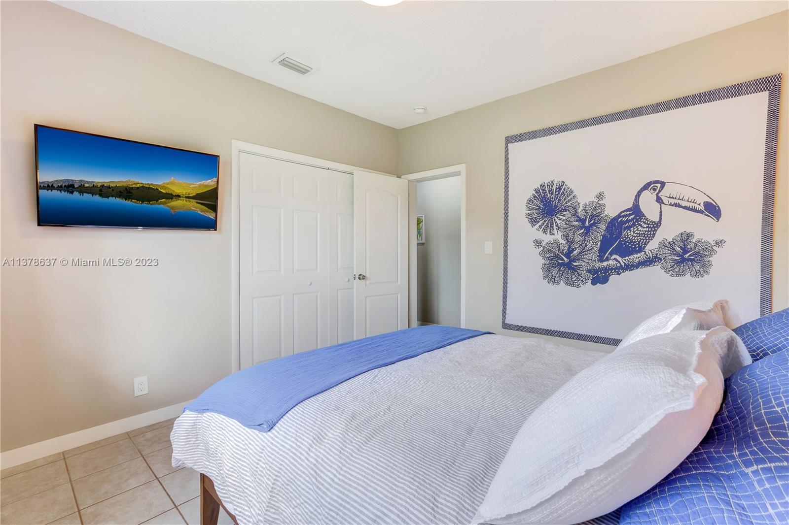 Bonaventure Lakes Weston, FL 33326 - Photo 32 of 52 a bedroom with a bed and a painting on the wall