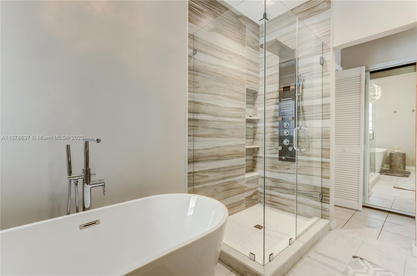 Bonaventure Lakes Weston, FL 33326 - Photo 36 of 52 a bathroom with a bathtub and a shower