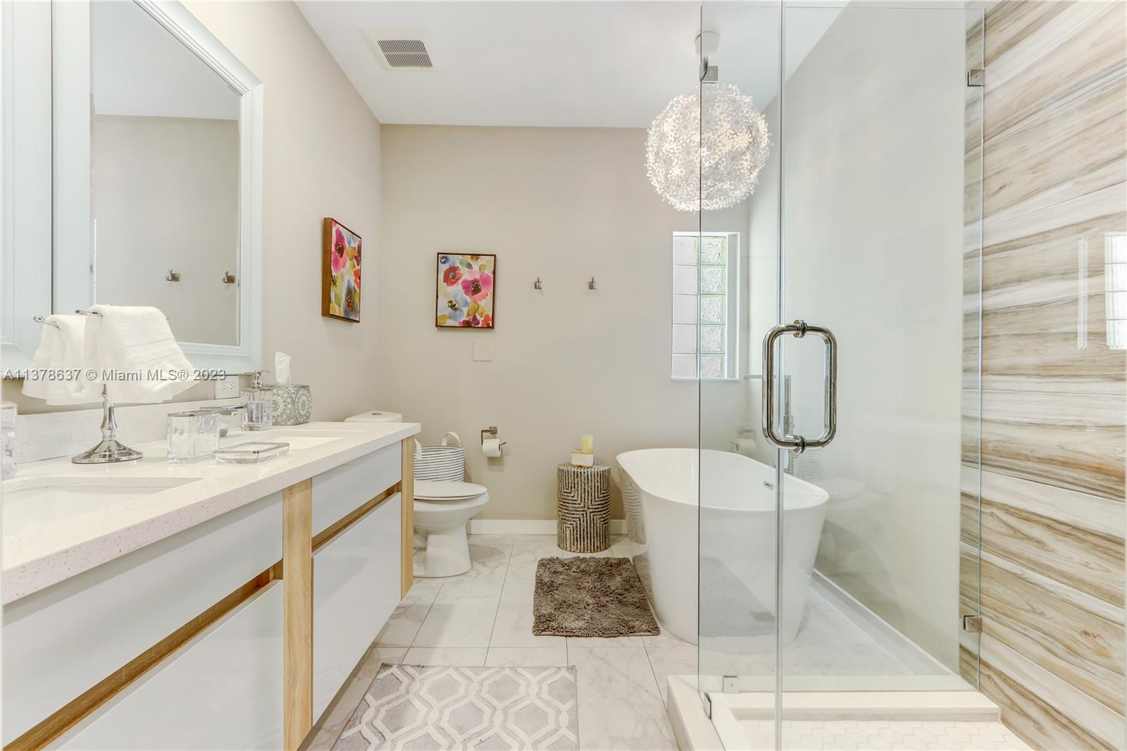 Bonaventure Lakes Weston, FL 33326 - Photo 37 of 52 a bathroom with a sink a toilet and a mirror