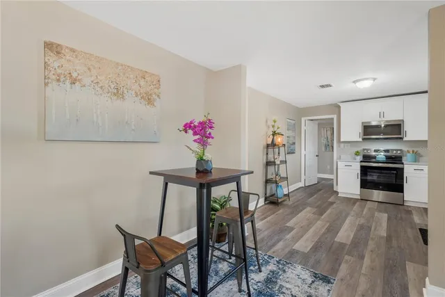 a view of a dining room with furniture and wooden floor