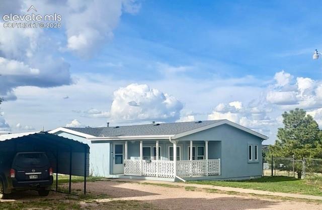 13335 Gymkhana Road Peyton, CO 80831 - Photo 38 of 38 Light blue single-story residence with a covered front porch featuring white railing