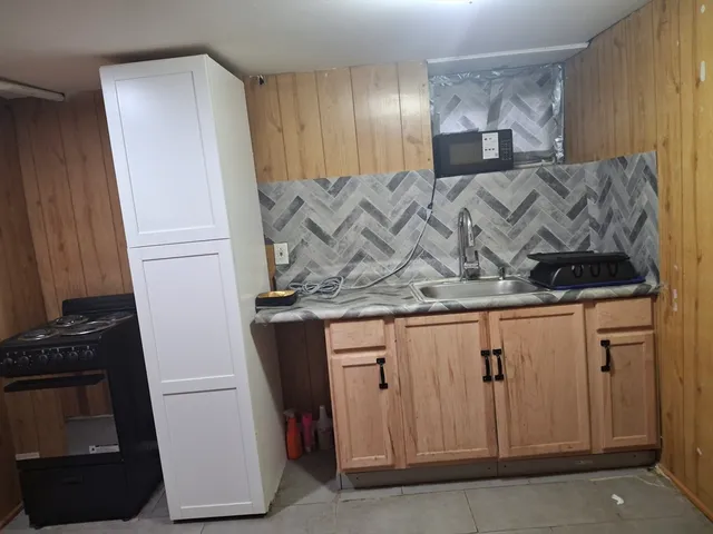 a close view of a sink a washer and dryer