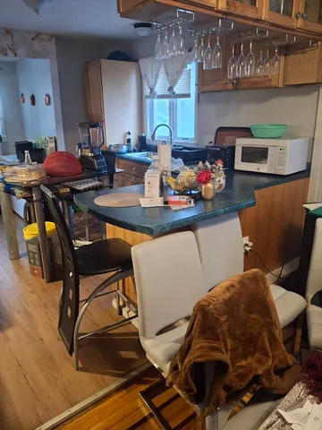 a kitchen with stainless steel appliances kitchen island granite countertop furniture and a dining table