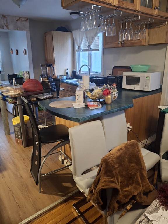 333 Lynnfield Street Lynn, MA 01904 - Photo 4 of 23 a kitchen with stainless steel appliances kitchen island granite countertop furniture and a dining table