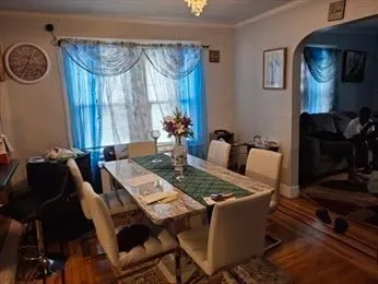 a view of a dining room with furniture and chandelier