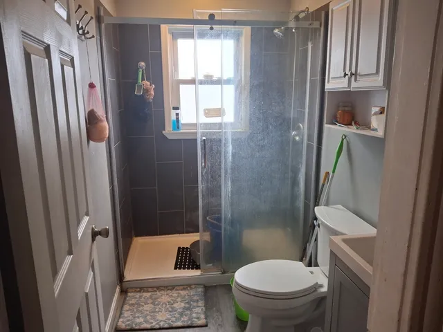 a bathroom with a toilet and a shower