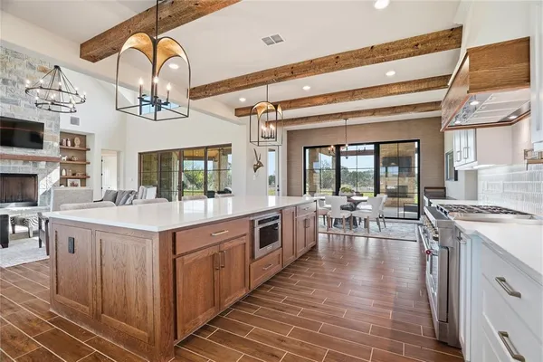 a open kitchen with stainless steel appliances granite countertop a stove and cabinets