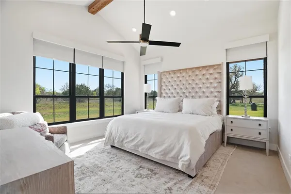 a bedroom with a bed and a large window