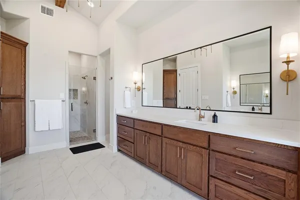 a bathroom with a double vanity sink and mirror