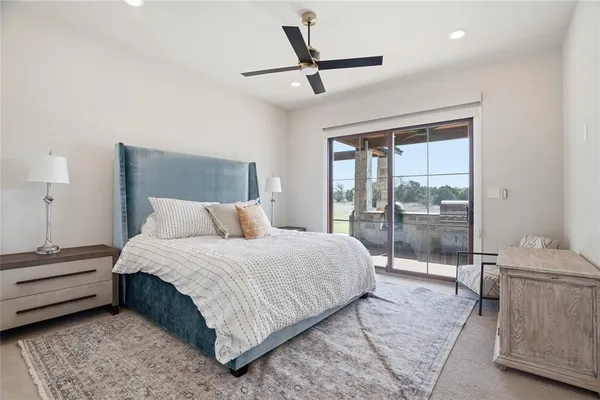 a bedroom with a bed and a large window