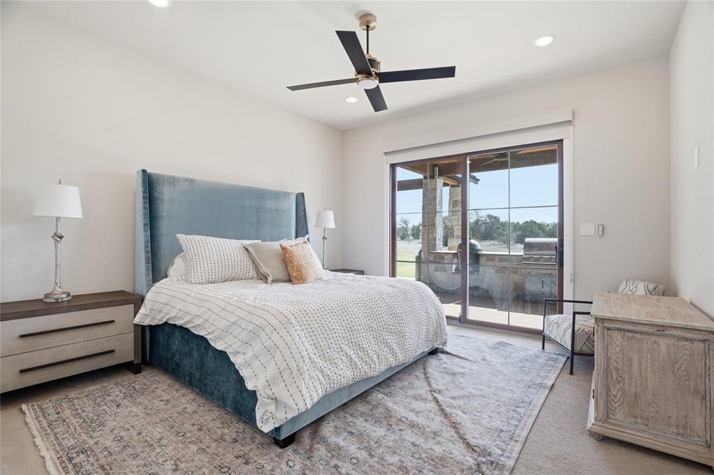 1010 Ranger Ridge Way Strawn, TX 76475 - Photo 31 of 40 a bedroom with a bed and a large window