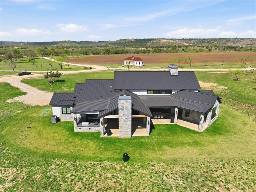 1010 Ranger Ridge Way Strawn, TX 76475 - Photo 36 of 40 an aerial view of a house with a garden and lake view