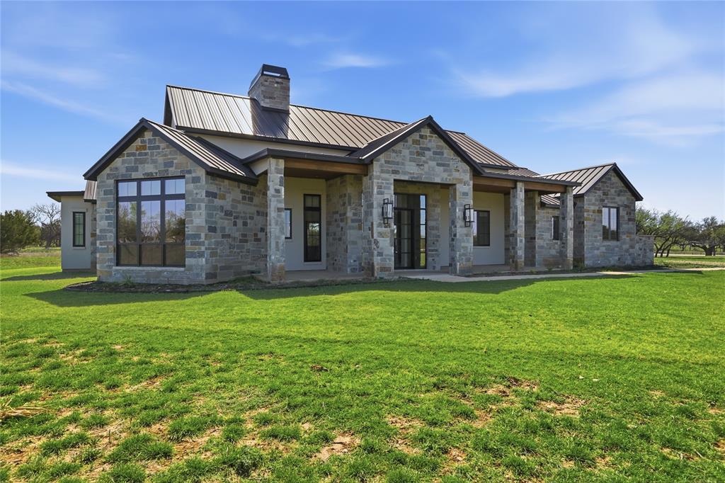 1010 Ranger Ridge Way Strawn, TX 76475 - Photo 5 of 40 a front view of a house with a garden