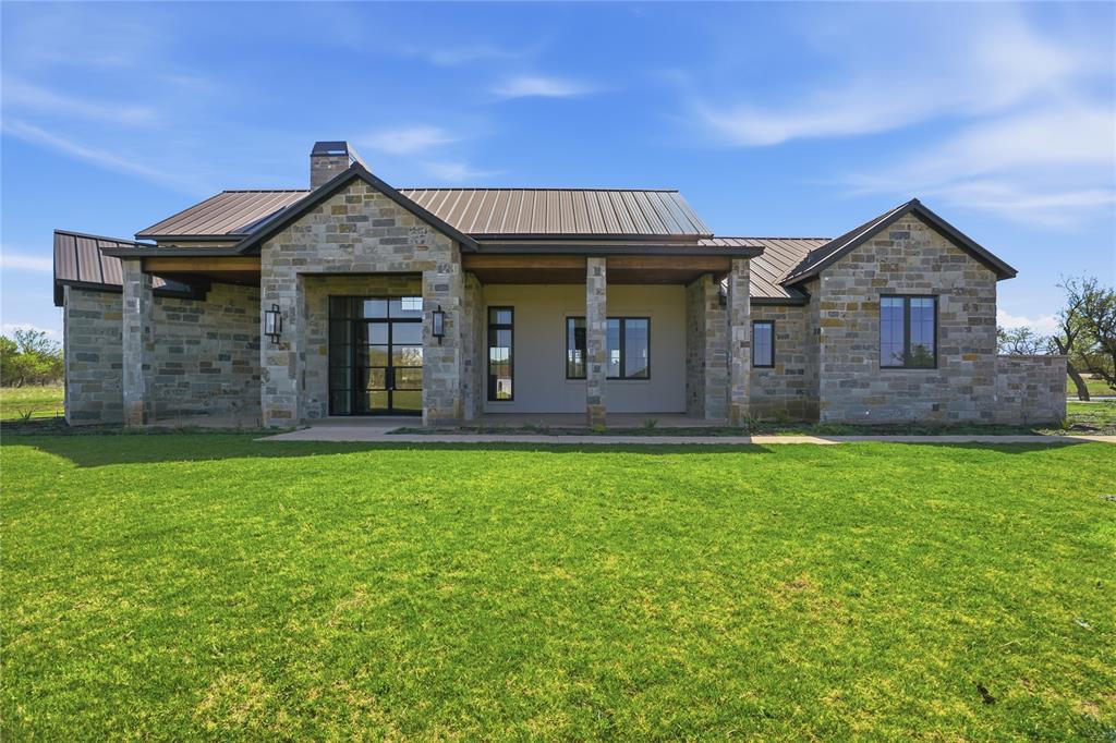 1010 Ranger Ridge Way Strawn, TX 76475 - Photo 6 of 40 front view of a house with a yard