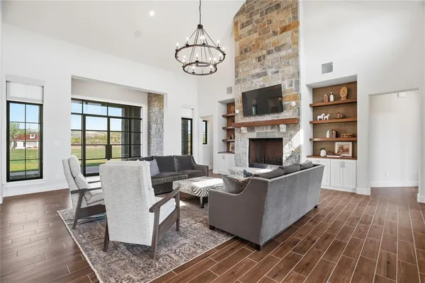 a living room with furniture a flat screen tv and a fireplace