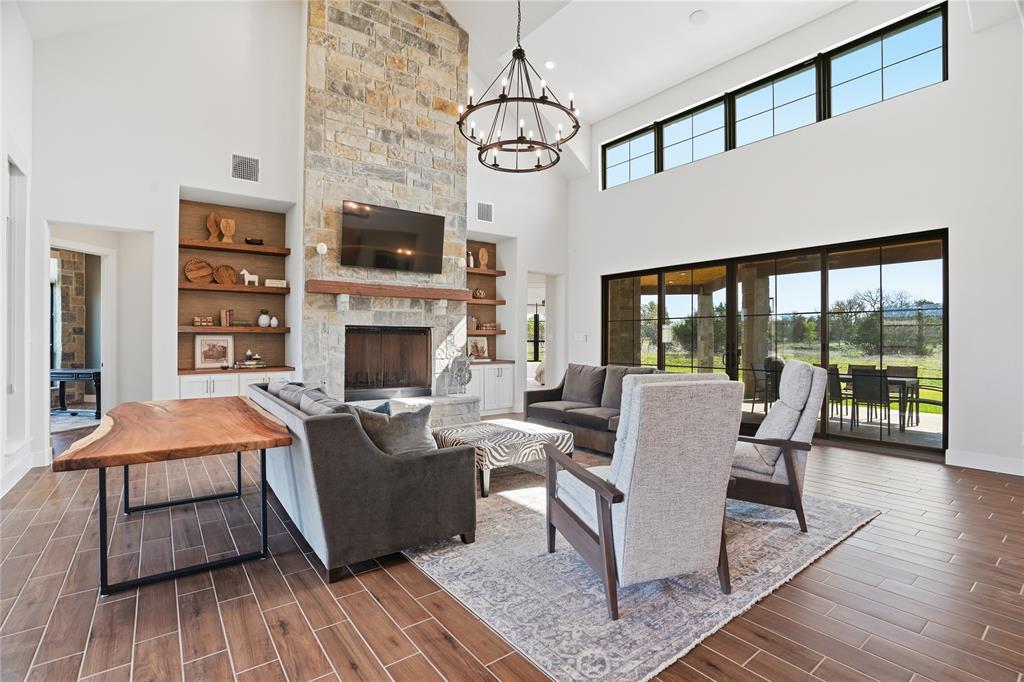 1010 Ranger Ridge Way Strawn, TX 76475 - Photo 9 of 40 a living room with fireplace furniture and a flat screen tv
