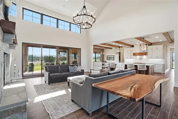 a living room with fireplace furniture and a rug