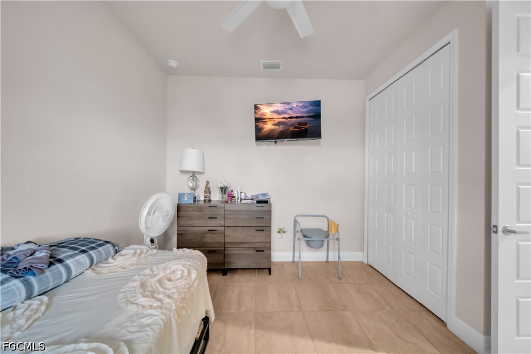 384 Neighborly Road LaBelle, FL 33935 - Photo 19 of 45 a bedroom with furniture and a flat screen tv