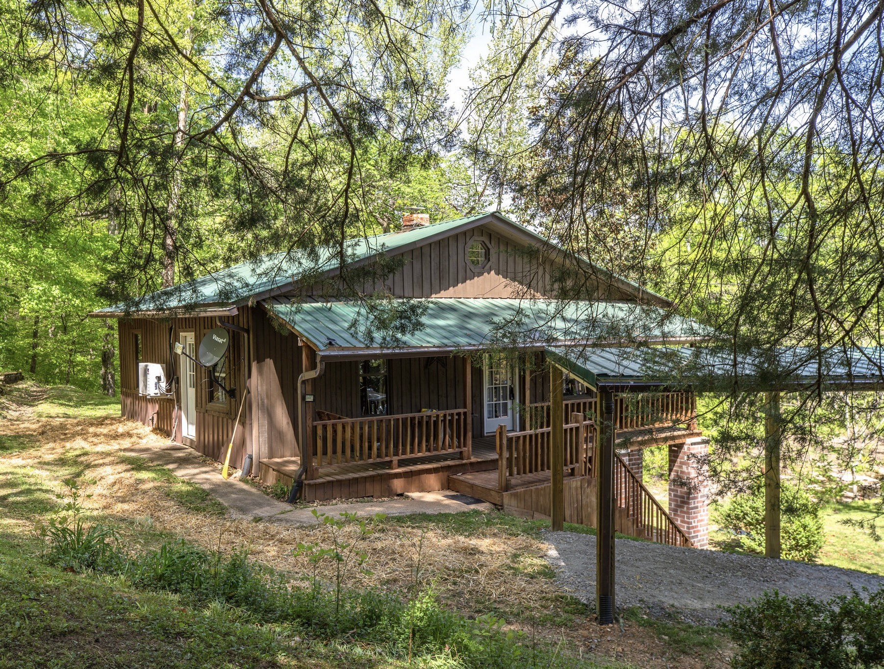 a view of backyard with a barn and a large tree