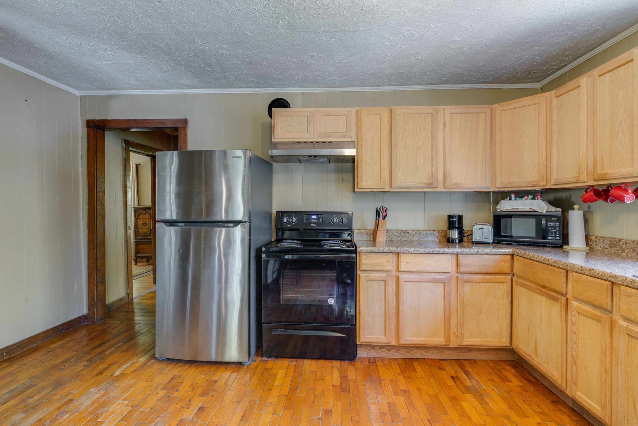 7196 Pinewood Road Nunnelly, TN 37137 - Photo 11 of 49 a kitchen with a refrigerator and a stove top oven