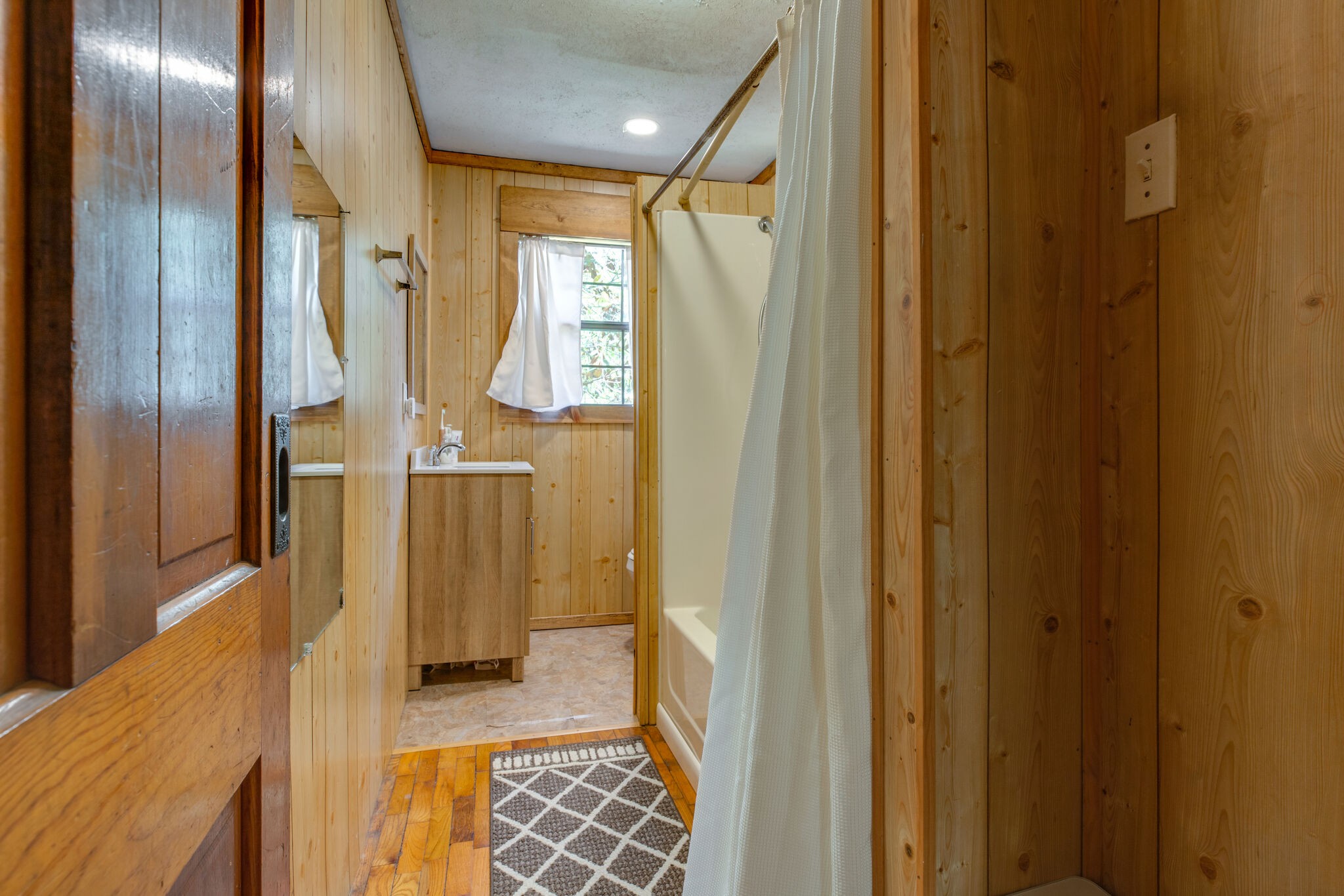 7196 Pinewood Road Nunnelly, TN 37137 - Photo 14 of 49 a bathroom with a glass shower door and a sink