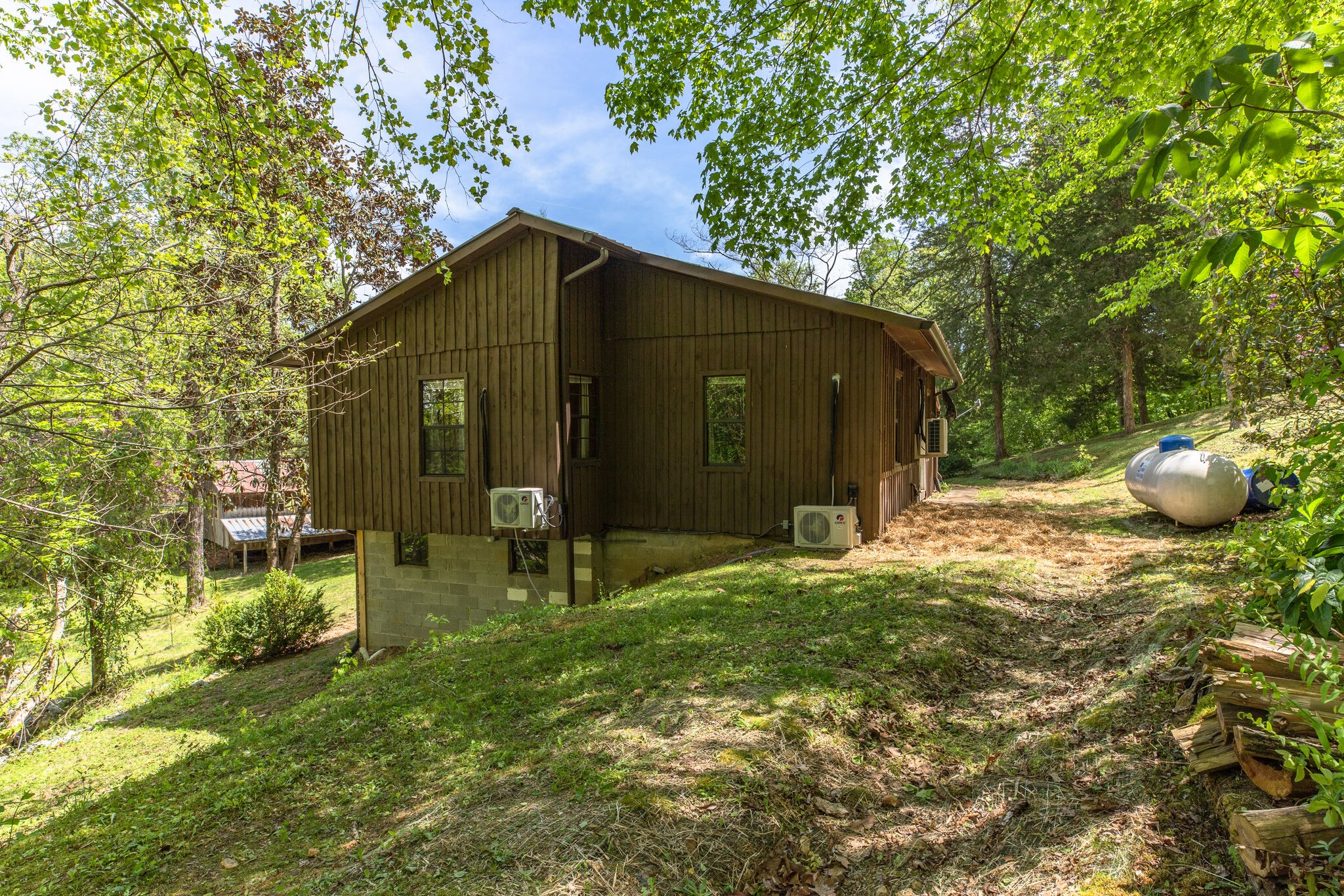 7196 Pinewood Road Nunnelly, TN 37137 - Photo 27 of 49 a backyard of a house with table and chairs