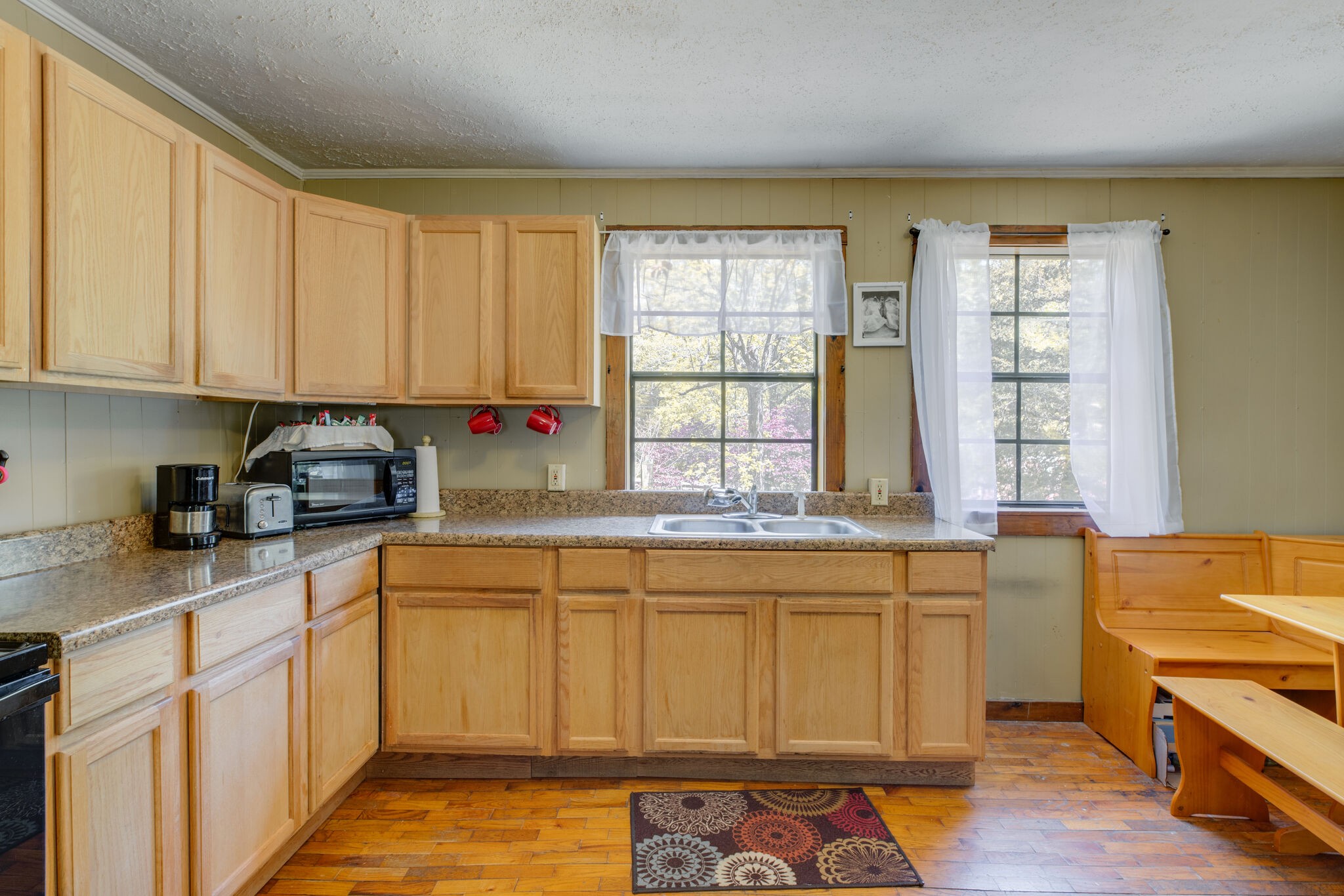 7196 Pinewood Road Nunnelly, TN 37137 - Photo 10 of 49 a kitchen with stainless steel appliances granite countertop a sink and cabinets