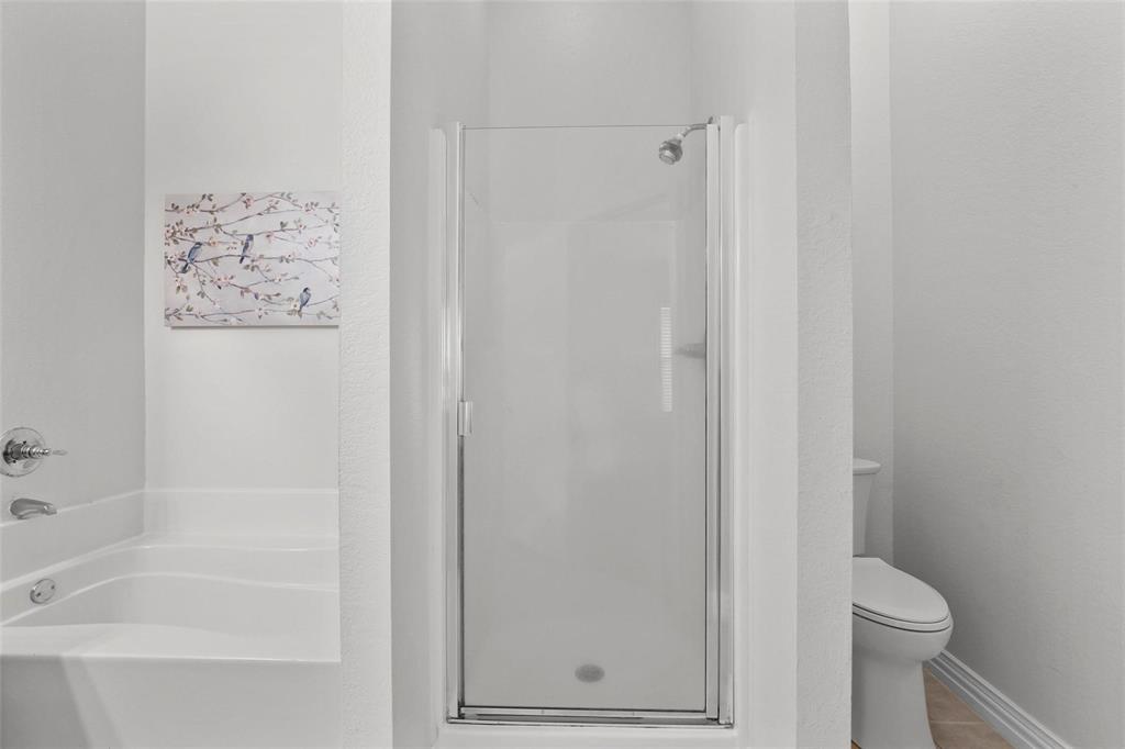 5961 Cheyenne Way Frisco, TX 75034 - Photo 23 of 33 Enclosed shower with clear glass door, chrome fixtures, and a soaking tub featuring a chrome faucet